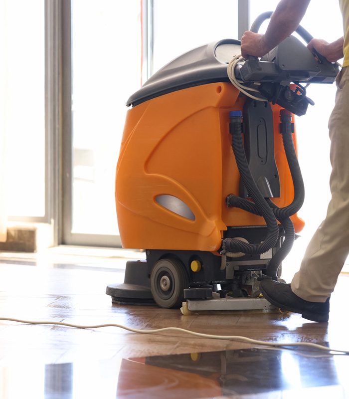 Cleaner washing floor in hotel using special machine closeup. Professional office cleaning concept